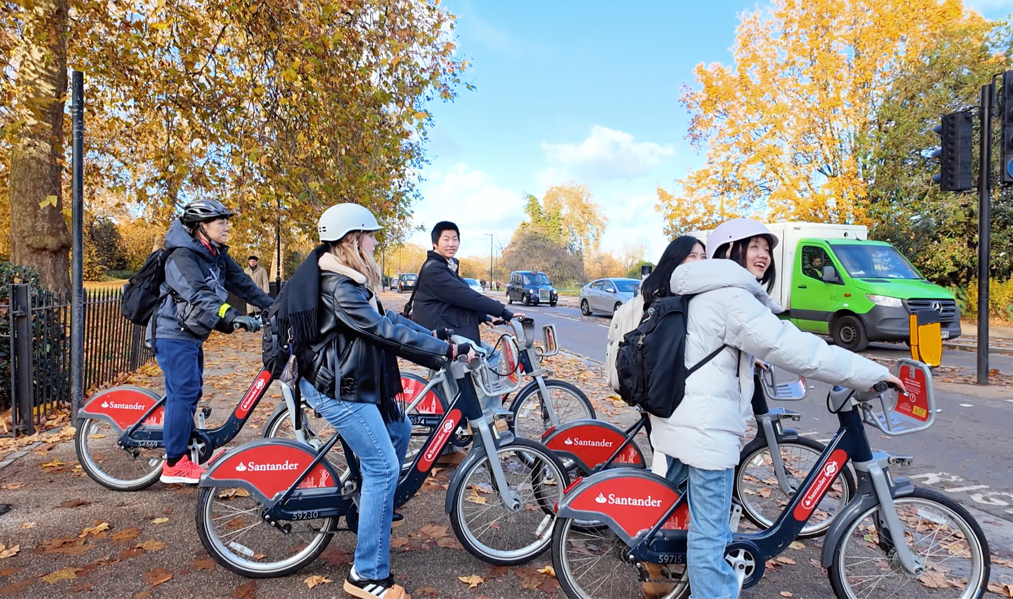 Women students cycling together during a Cycle Venner activity.